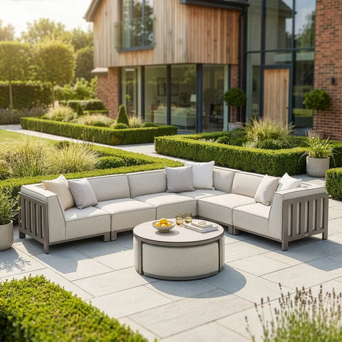 Light grey outdoor corner sofa set with round coffee table on modern garden patio