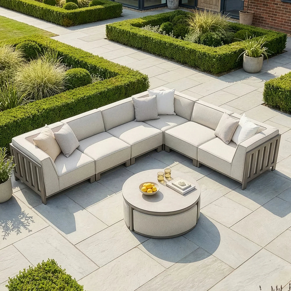 Beige outdoor corner sofa set with cushions and circular coffee table on patio