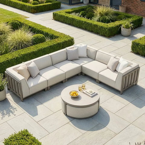 Beige outdoor corner sofa set with cushions and circular coffee table on patio