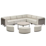Beige outdoor corner sofa set with metal frame, three curved stools, and round coffee table