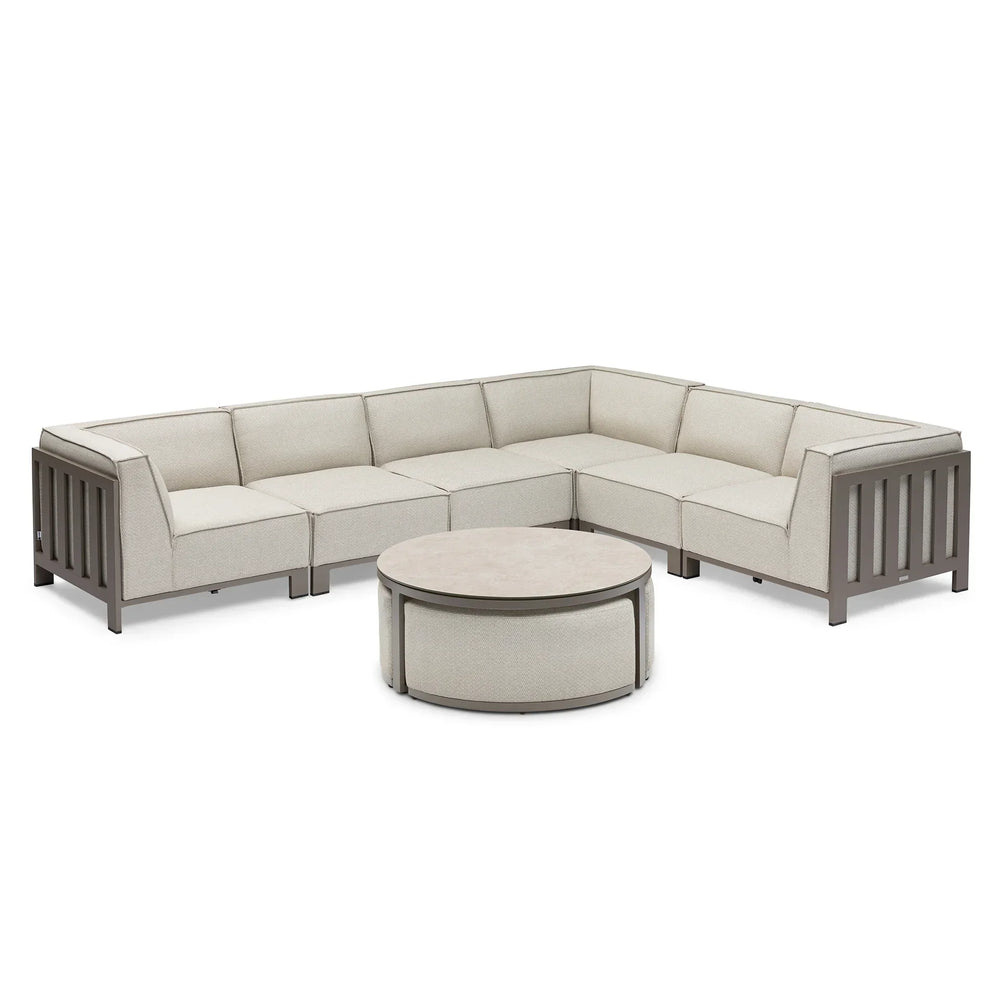 Beige modular corner sofa set with grey metal frame and round coffee table on white background