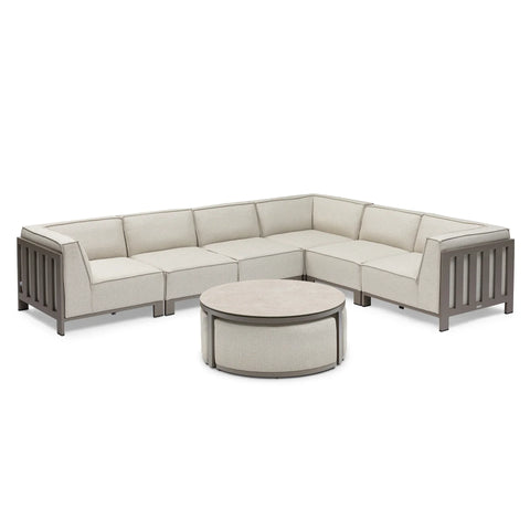 Beige modular corner sofa set with grey metal frame and round coffee table on white background