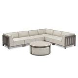 Beige modular corner sofa set with grey metal frame and round coffee table on white background
