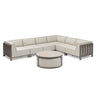 Beige modular corner sofa set with grey metal frame and round coffee table on white background