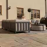 Grey outdoor sofa set with cushions and round coffee table on patio