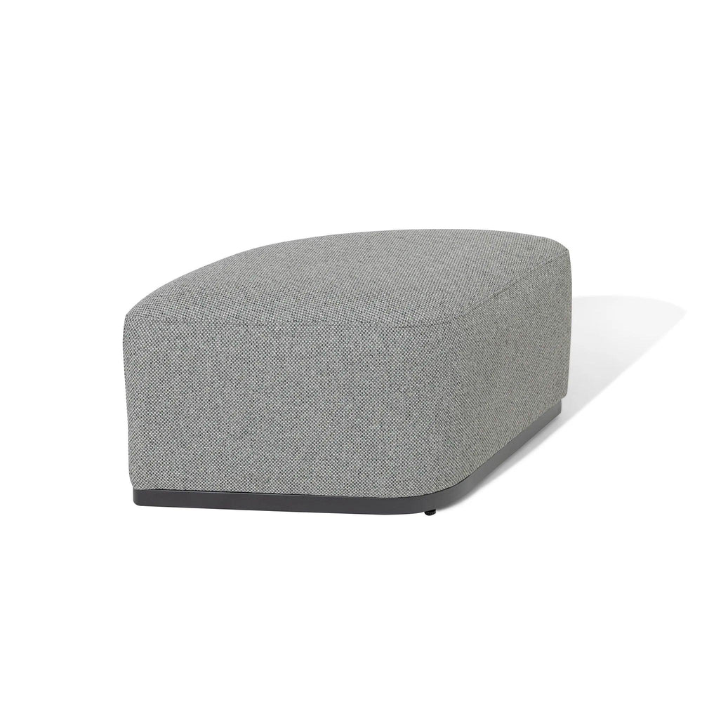 Grey fabric ottoman with curved edges and low black base on white background