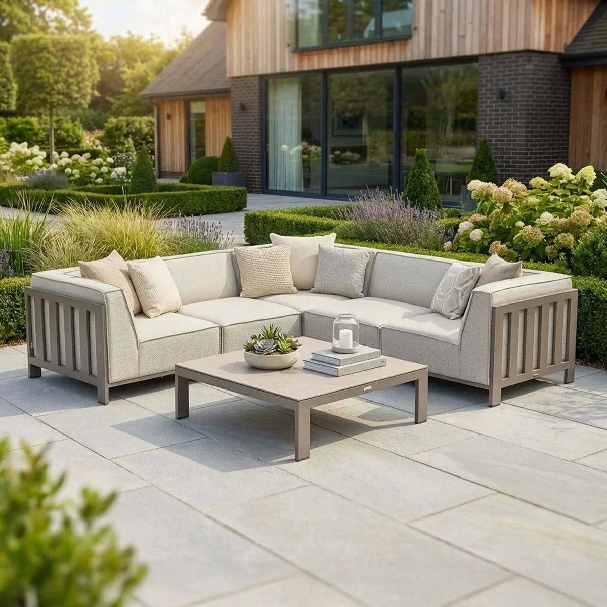 Beige outdoor corner sofa set with cushions and coffee table on stone patio