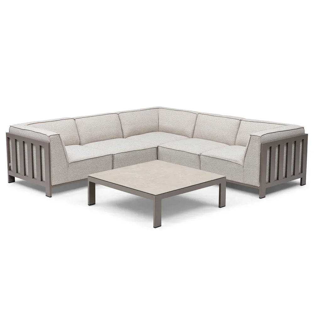 Beige corner sofa set with metal frame and low square coffee table on white background