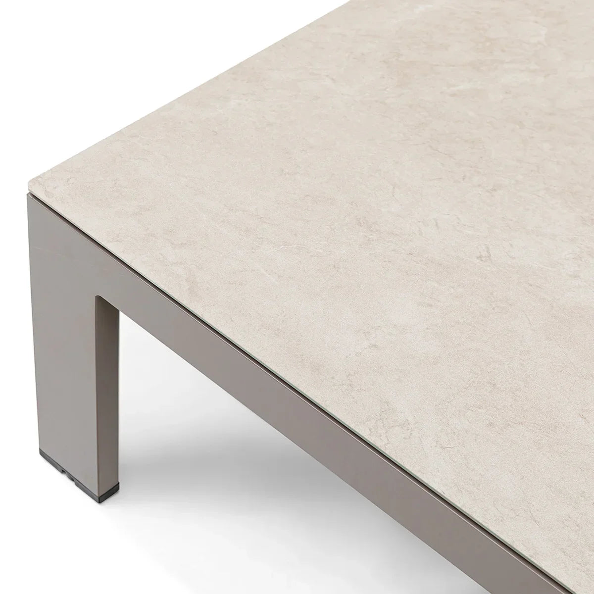 Closeup of beige stone effect coffee table with grey metal legs