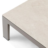 Closeup of beige stone effect coffee table with grey metal legs