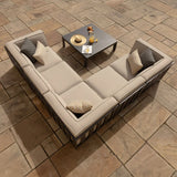 Beige outdoor corner sofa set with cushions and square coffee table on stone patio