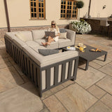 Outdoor corner sofa set with beige cushions and coffee table on stone patio