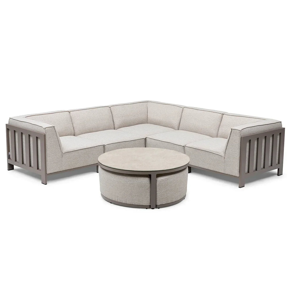 Beige fabric corner sofa with metal frame and round coffee table on white background