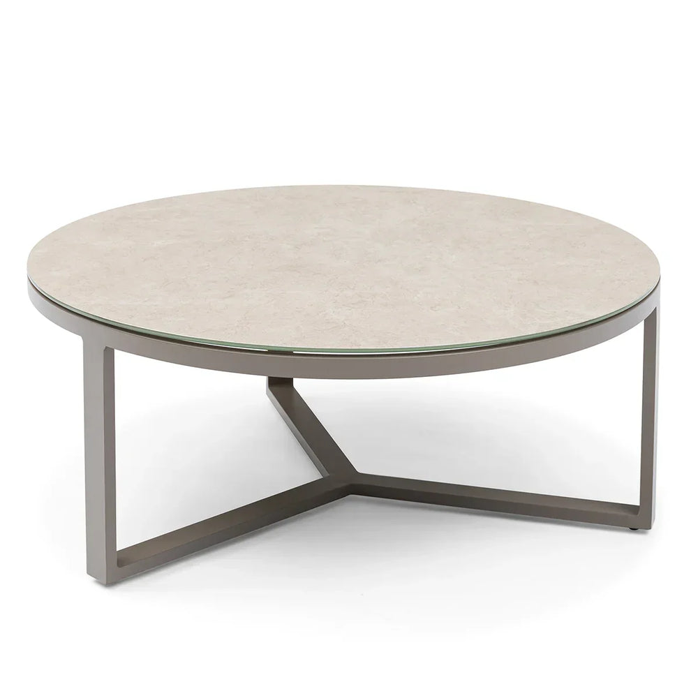 Round coffee table with beige stone top and metal frame on white background
