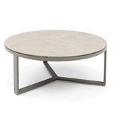 Round coffee table with beige stone top and metal frame on white background