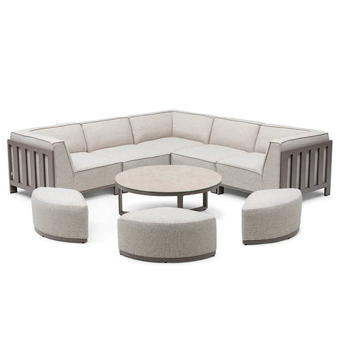 Beige sectional outdoor sofa set with three curved stools and round coffee table