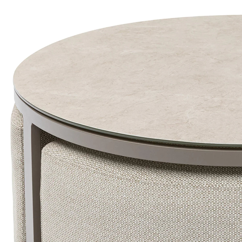 Round coffee table with beige stone effect top and textured fabric sides