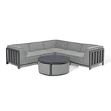 Grey corner outdoor sofa set with matching round coffee table on white background