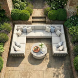 Outdoor sectional sofa with light cushions and round coffee table on stone patio