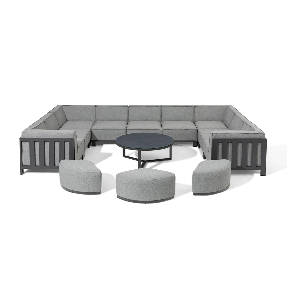 Grey modular corner sofa set with three ottomans and round black coffee table