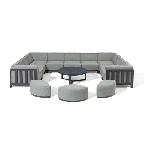 Grey modular corner sofa set with three ottomans and round black coffee table