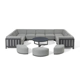 Grey modular corner sofa set with three ottomans and round black coffee table