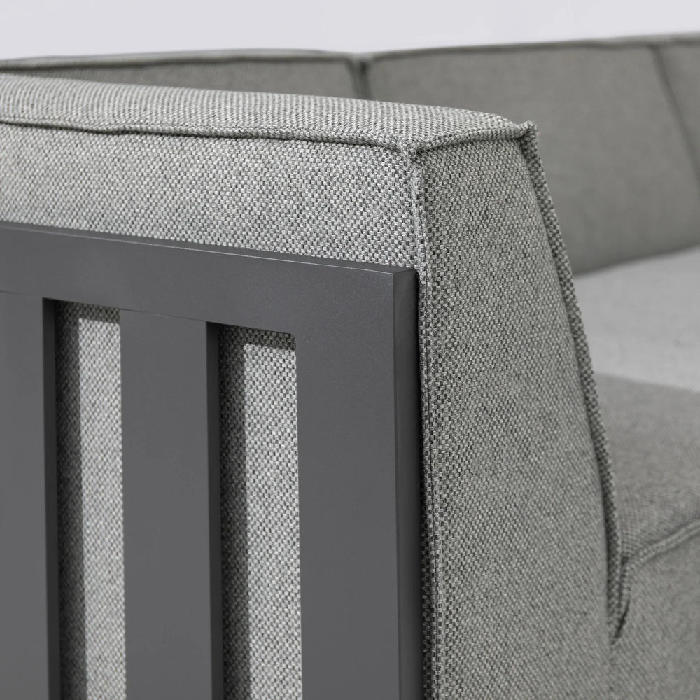 Close up of grey fabric sofa arm with metal panel detail
