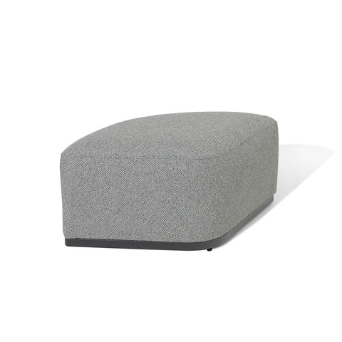 Grey fabric ottoman with rounded edges and black base, angled on white background