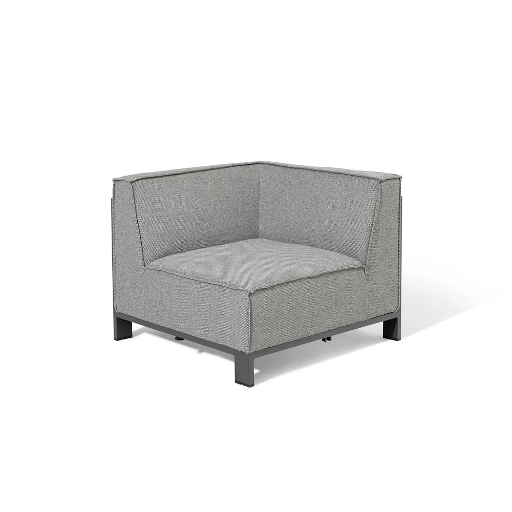 Grey corner sofa chair with metal legs and boxy cushions on white background