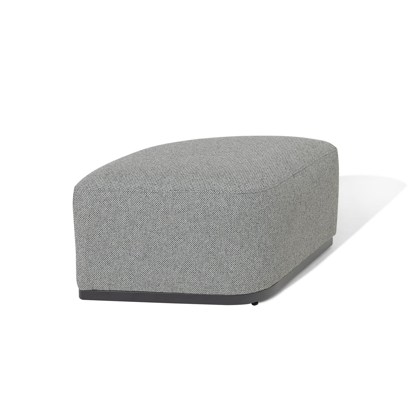 Grey fabric footstool with curved edges and black base on white background