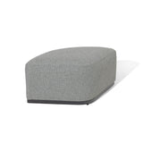 Grey fabric footstool with curved edges and black base on white background
