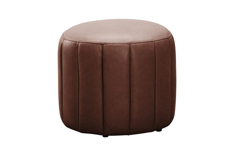A round brown faux leather ottoman with vertical channel tufting on a solid white background.