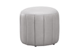 A round, light gray upholstered ottoman with vertical channel tufting, shown against a plain white background.