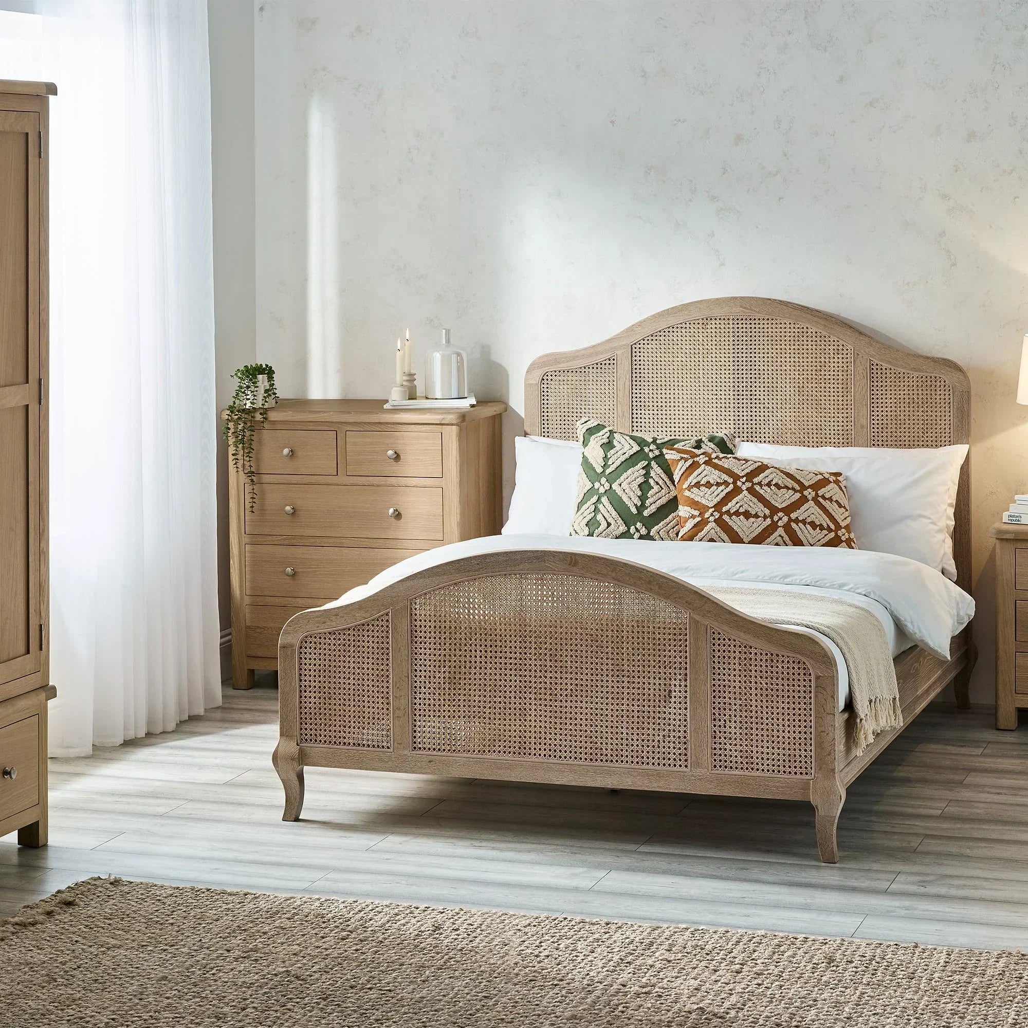 Fleur rattan bed double size with cane headboard and footboard in bright bedroom setting