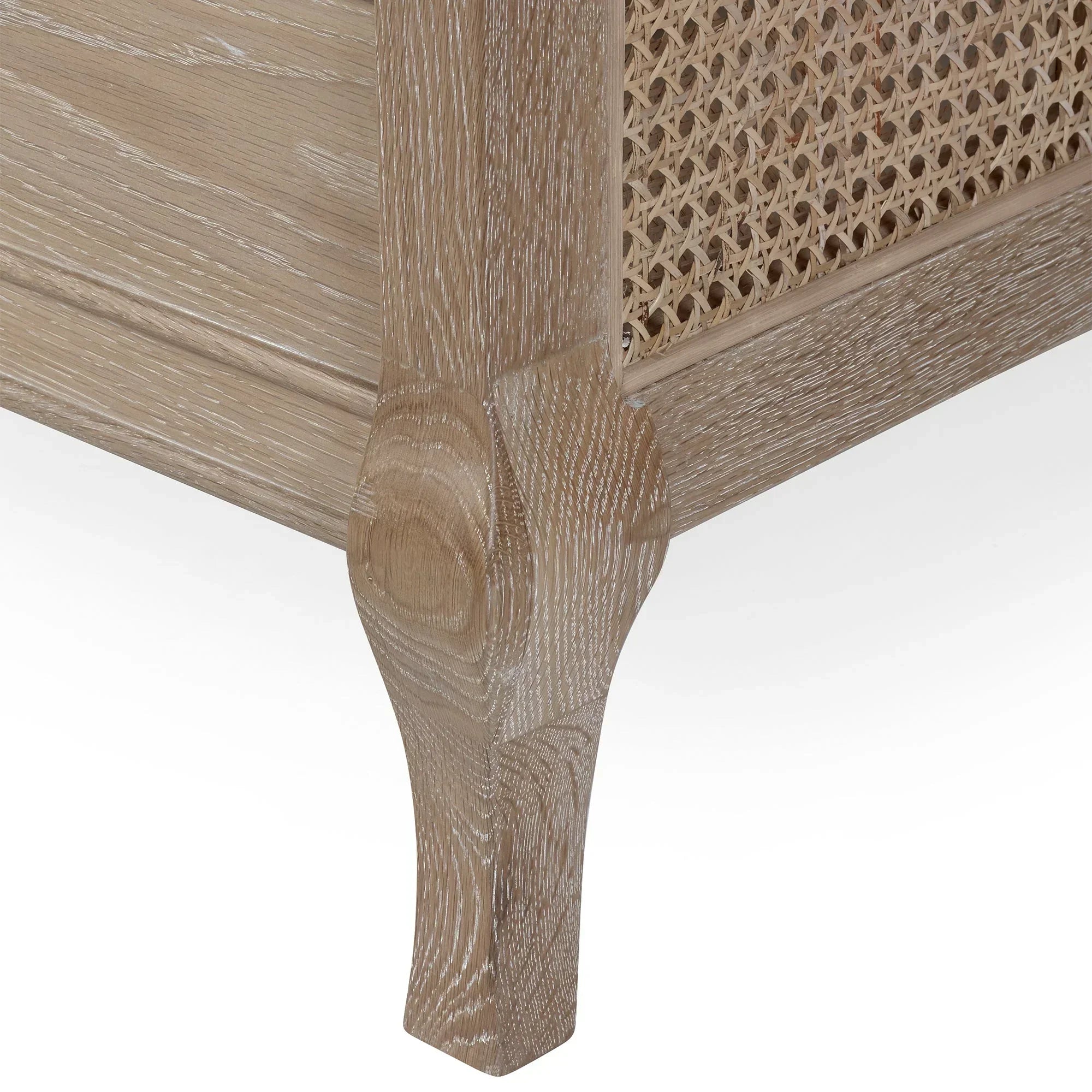 Oak wood furniture leg with woven rattan panel detail, close-up angle