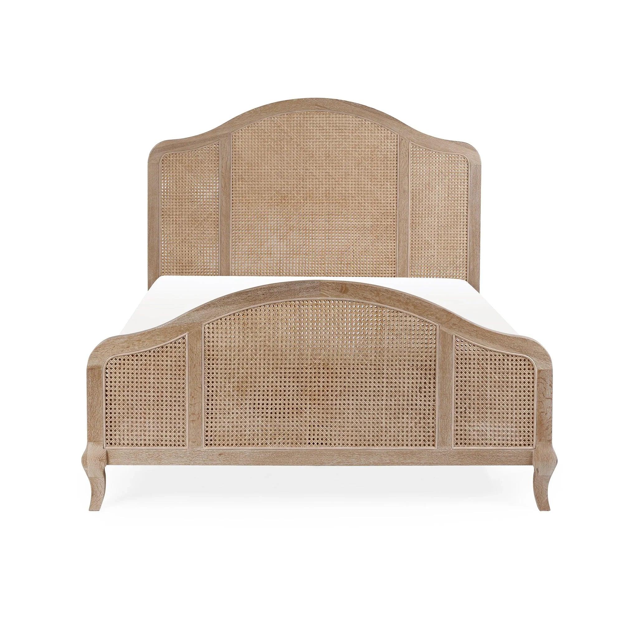 Natural rattan bed frame with curved wooden headboard and footboard, front view