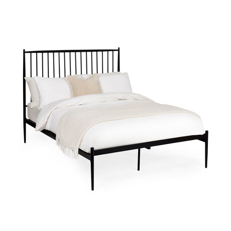 Black metal spindle bed with white bedding and beige throw, angled view on a white background