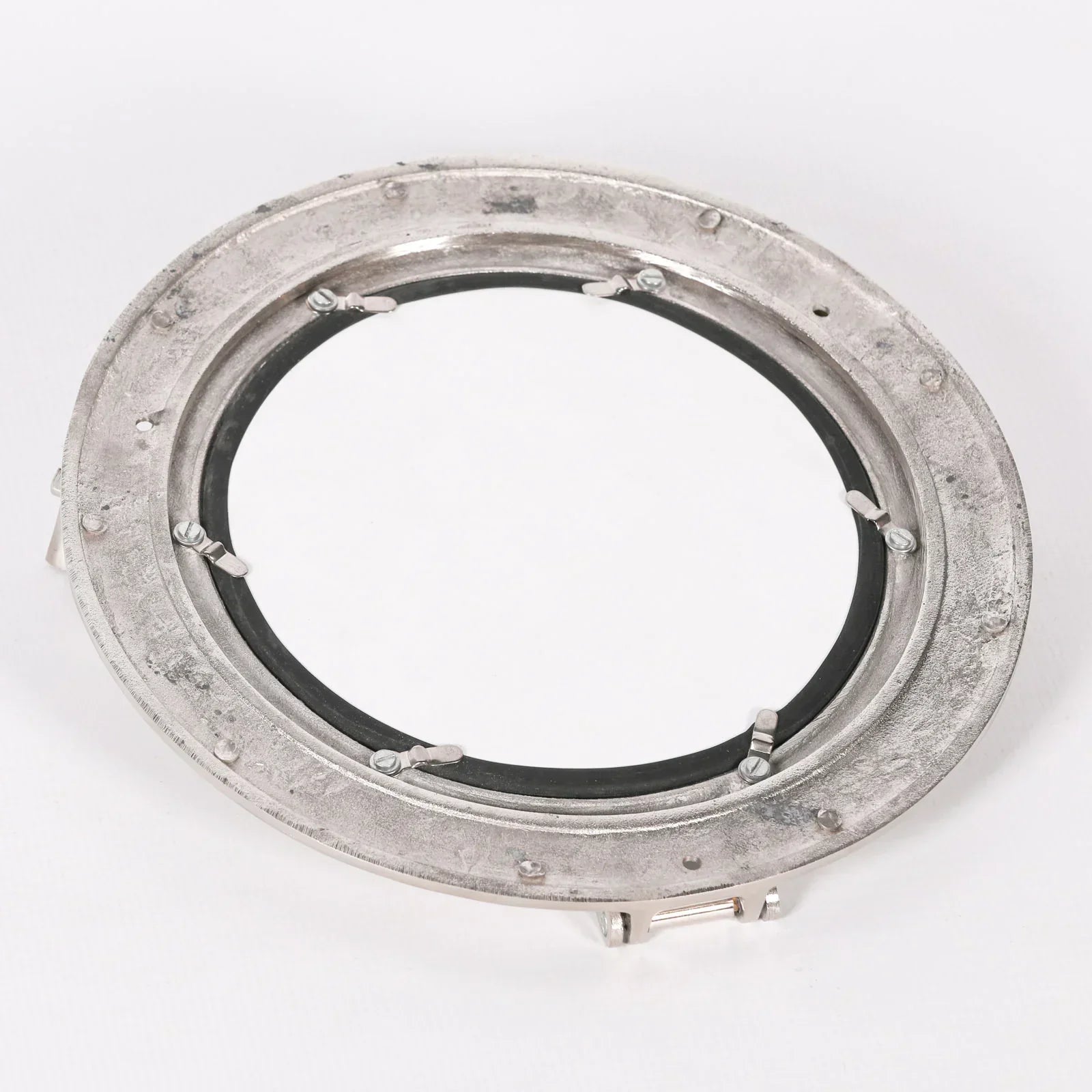 Back view of round metal porthole mirror with visible mounting brackets and fixings