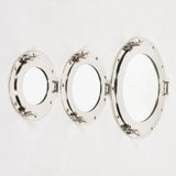 Set of three round porthole mirrors with chrome frames displayed on white wall