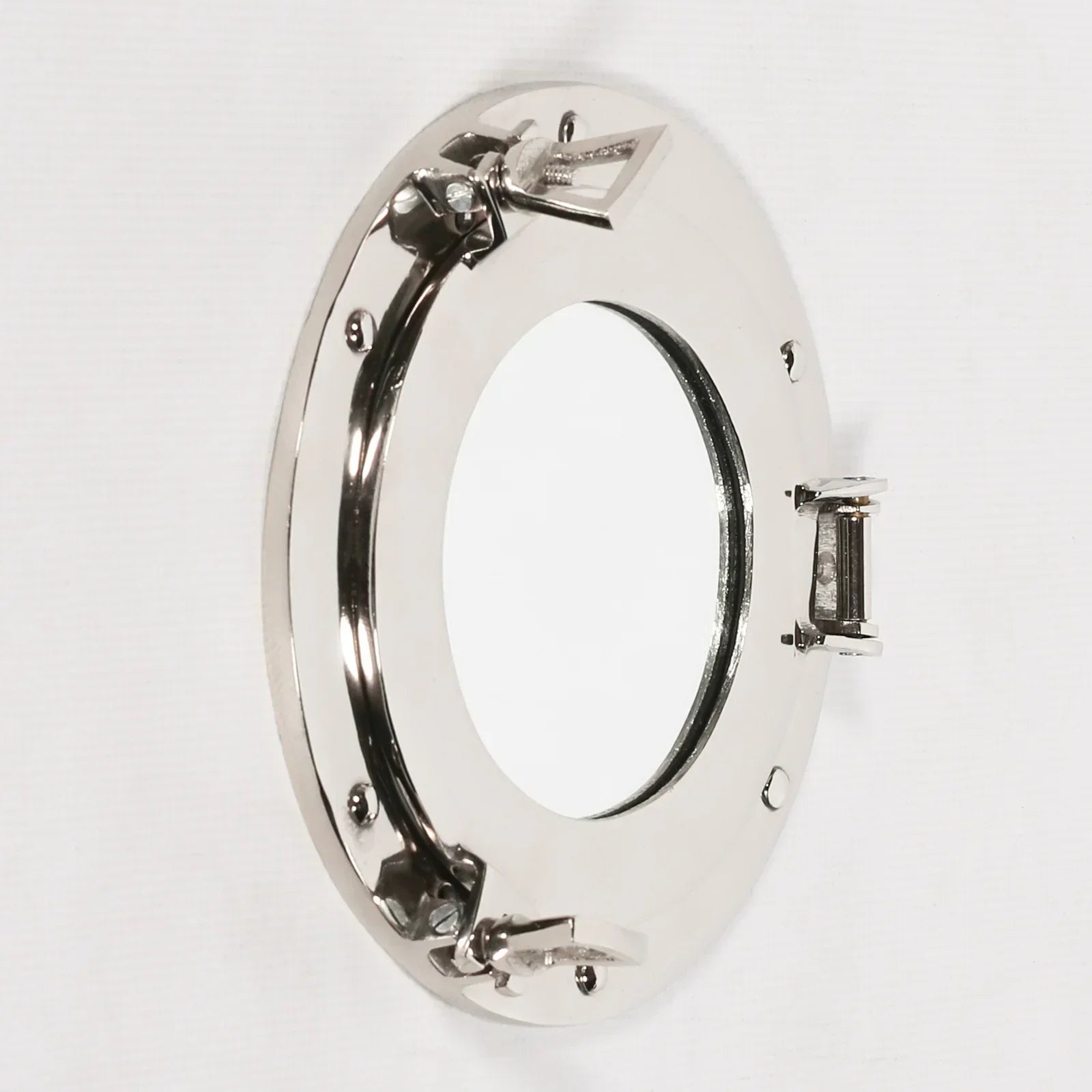 Round porthole wall mirror with polished chrome frame and secure hinge detail