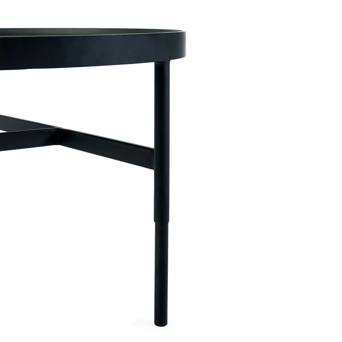 Closeup of round glass coffee table with black metal frame and angled leg detail