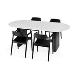 Four black wooden dining chairs with curved backrests around white oval dining table with black pedestal legs.