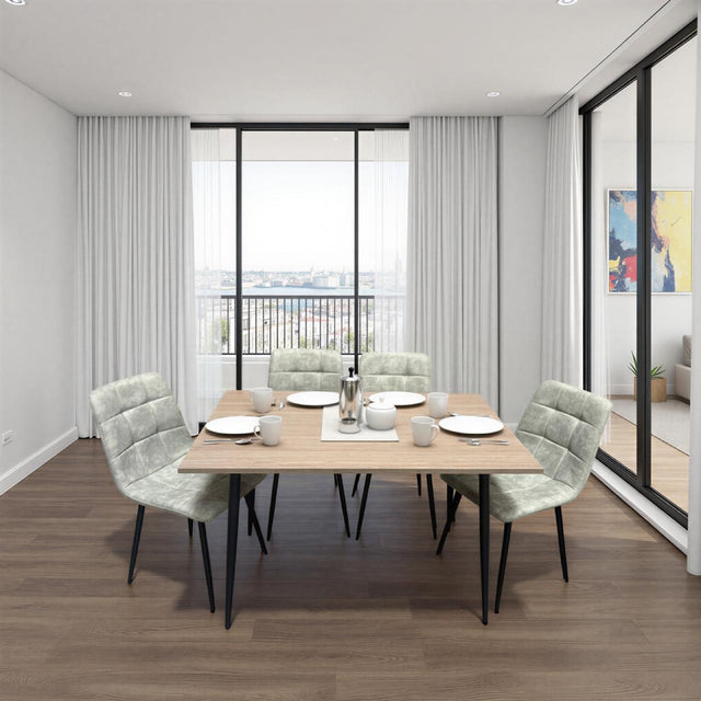 Dining area with a wooden table and chairs in a modern room with large windows.