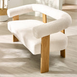 Close-up angled shot of cream boucle 2 seater sofa showing armrest, curved backrest and light wood frame
