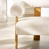 Close-up detail of cream boucle fabric seat and tubular curved backrest supported by wooden frame