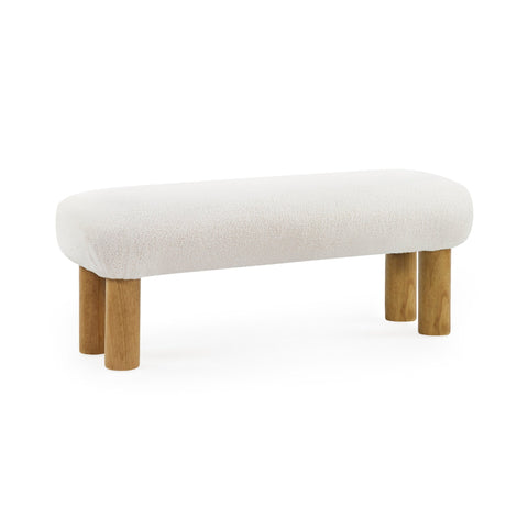 Cream low bench with round wooden legs isolated on white background, angled view.