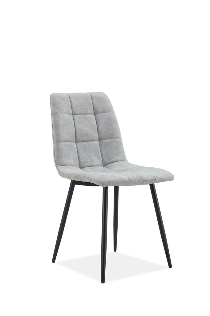 A modern dining chair with a light gray tufted velvet upholstered seat and backrest, supported by slim black metal legs, shown against a plain white background.