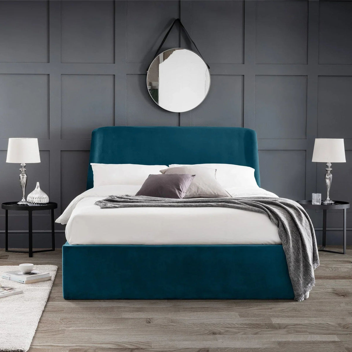Teal velvet upholstered bed with curved headboard in grey panelled bedroom