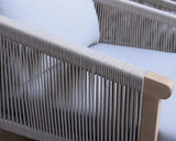 Close view of outdoor rope armchair with light grey cushions and wooden frame