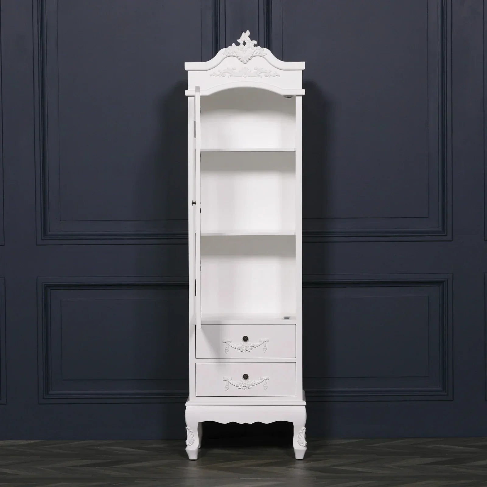 White tall display cabinet with glass door, three shelves and two drawers, ornate detailing
